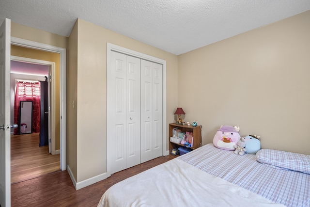 20 Sunderland Dr, Auburn, ME 04210 - bedroom featuring a closet, wood finished floors, baseboards, and a textured ceiling