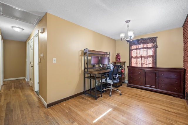 20 Sunderland Dr, Auburn, ME 04210 - office area with light wood finished floors, baseboards, a chandelier, and a textured ceiling