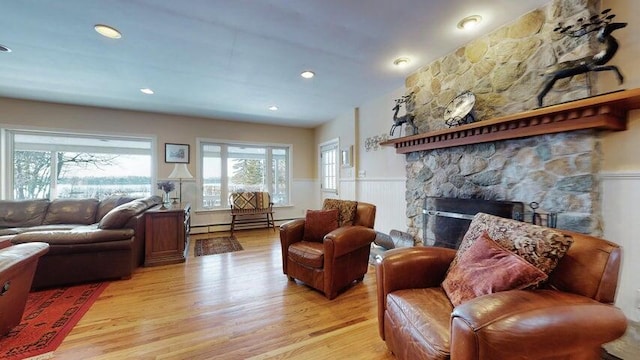 72 Sand Beach Rd, Standish, ME 04084 - living area featuring wainscoting, light wood finished floors, a baseboard heating unit, and a fireplace