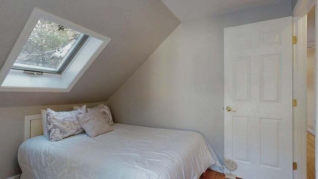 72 Sand Beach Rd, Standish, ME 04084 - bedroom with a skylight, lofted ceiling, and wood finished floors