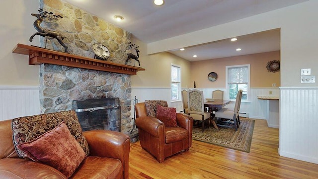 72 Sand Beach Rd, Standish, ME 04084 - living area with wainscoting, wood finished floors, a fireplace, a decorative wall, and recessed lighting