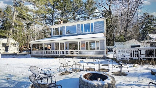 72 Sand Beach Rd, Standish, ME 04084 - snow covered house featuring an outdoor fire pit and a patio