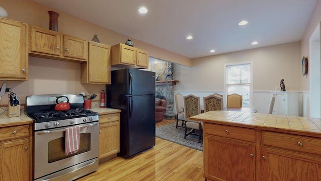 72 Sand Beach Rd, Standish, ME 04084 - kitchen with gas stove, freestanding refrigerator, tile countertops, light wood-style floors, and recessed lighting