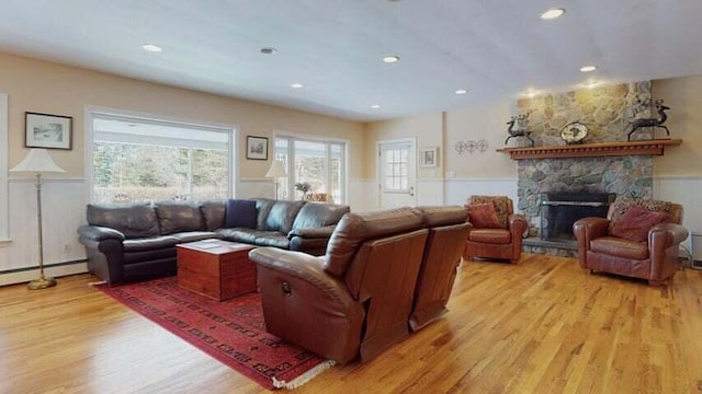 72 Sand Beach Rd, Standish, ME 04084 - living area featuring light wood-style flooring, a wainscoted wall, a baseboard heating unit, a fireplace, and recessed lighting