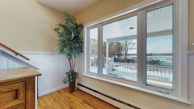 72 Sand Beach Rd, Standish, ME 04084 - detailed view of a baseboard radiator, wood finished floors, and a wainscoted wall
