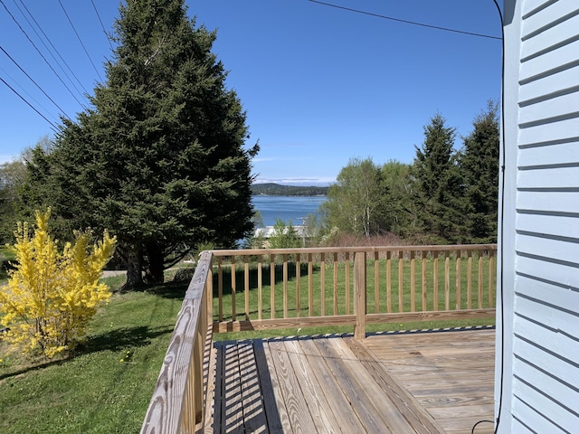 11 Brewster Rd, Eastport, ME 04631 - wooden terrace with a water view and a lawn