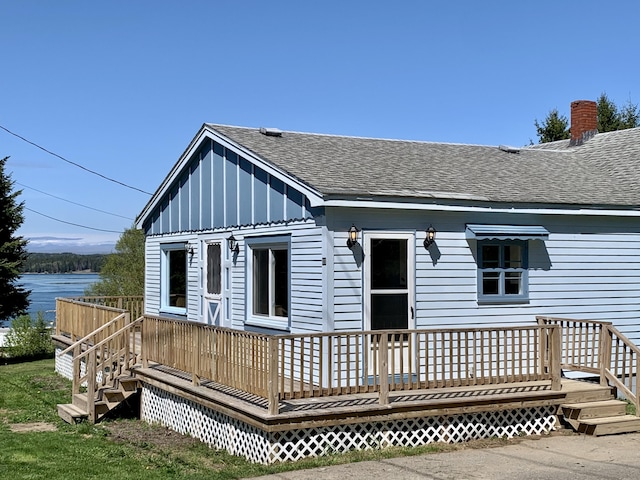 11 Brewster Rd, Eastport, ME 04631 - rear view of property with a shingled roof, a deck with water view, and board and batten siding