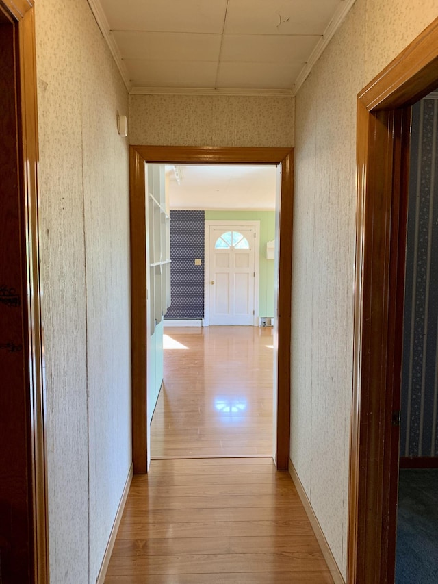 11 Brewster Rd, Eastport, ME 04631 - hallway with light wood-type flooring, wallpapered walls, and ornamental molding