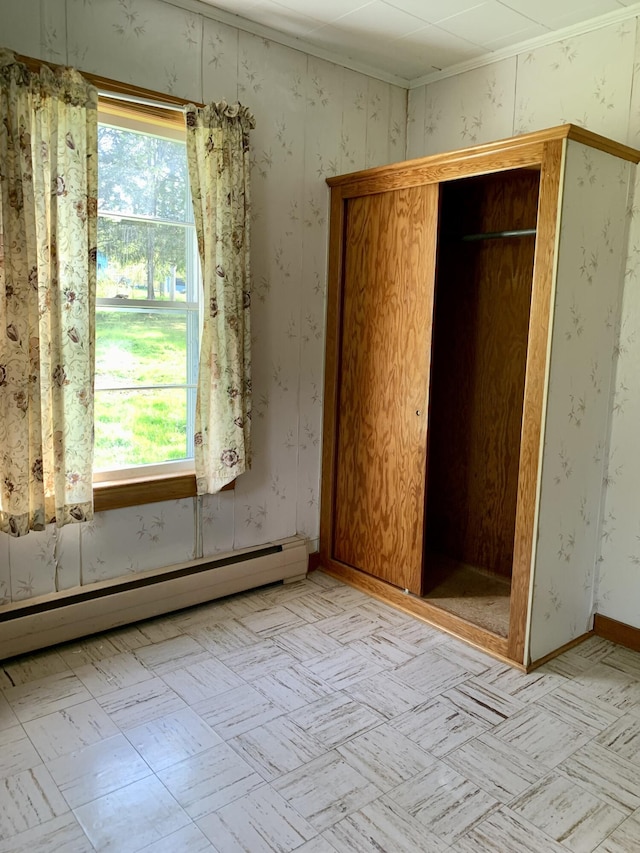 11 Brewster Rd, Eastport, ME 04631 - unfurnished bedroom with a baseboard radiator, multiple windows, and a closet