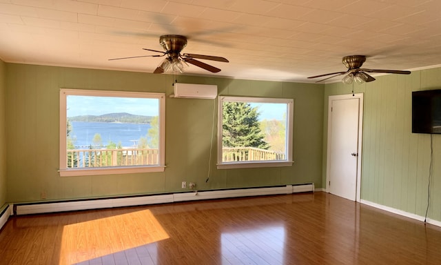 11 Brewster Rd, Eastport, ME 04631 - spare room with a ceiling fan, wood finished floors, baseboard heating, and a wall unit AC