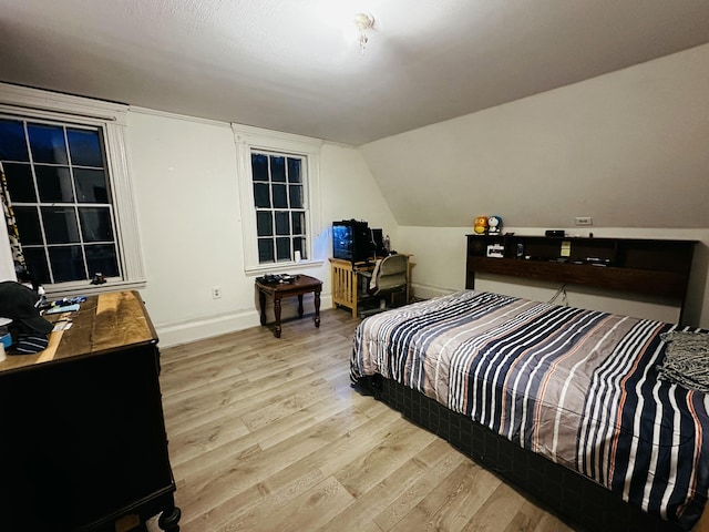 29 Fish Point Rd, Orland, ME 04472 - bedroom with light wood-style floors, baseboards, and lofted ceiling