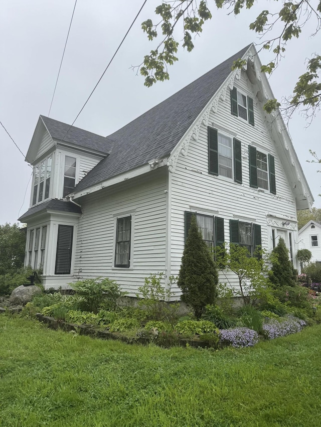 29 Fish Point Rd, Orland, ME 04472 - view of front of property featuring a shingled roof and a front yard