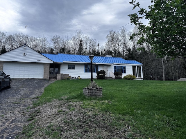 1596 Bald Mountain Rd, Orland, ME 04472 - single story home with a garage, a chimney, driveway, a front yard, and metal roof