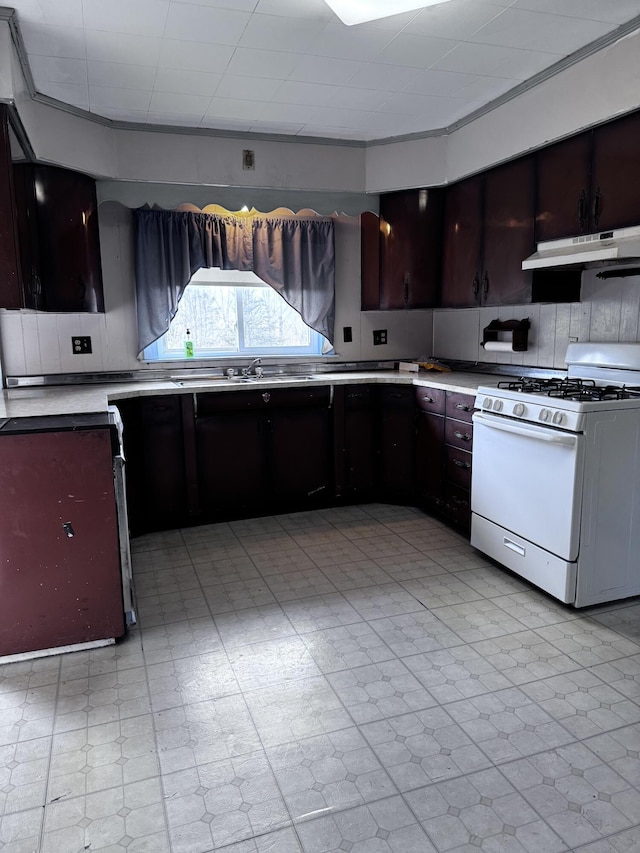 1596 Bald Mountain Rd, Orland, ME 04472 - kitchen with white range with gas cooktop, under cabinet range hood, a sink, light flooring, and light countertops