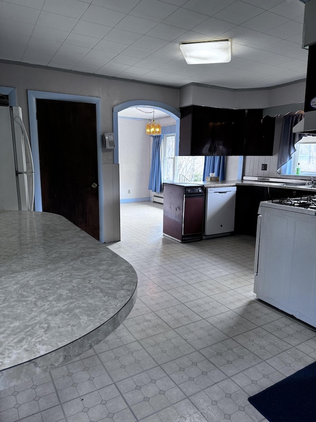 1596 Bald Mountain Rd, Orland, ME 04472 - kitchen featuring white dishwasher, freestanding refrigerator, a chandelier, arched walkways, and tasteful backsplash