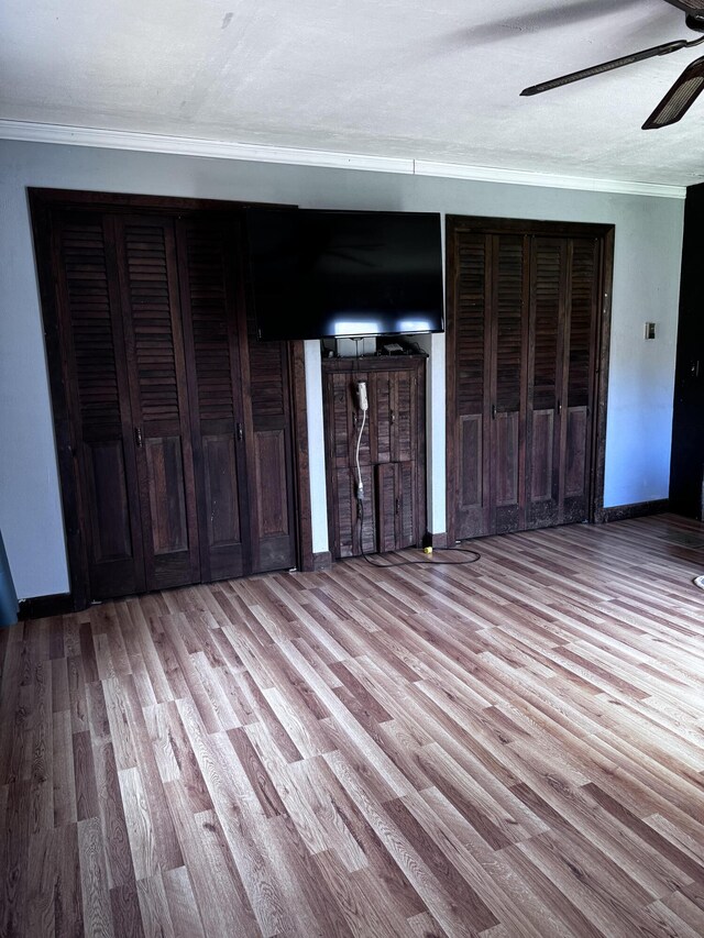 1596 Bald Mountain Rd, Orland, ME 04472 - unfurnished living room with crown molding, wood finished floors, ceiling fan, and baseboards