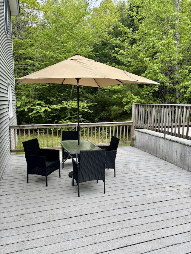 51 Brookview Dr, Bucksport, ME 04416 - deck with outdoor dining space and a forest view