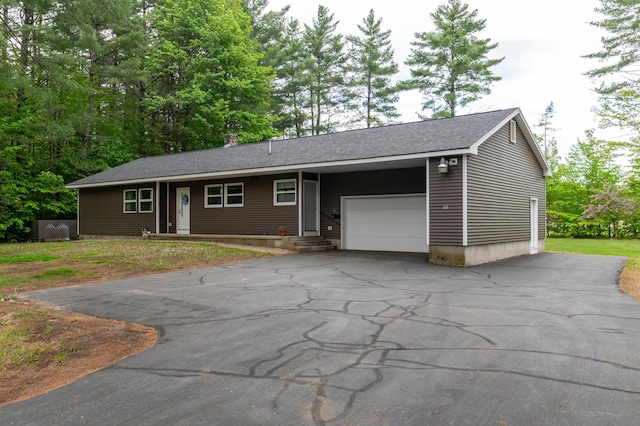 55 Woodland St, Fryeburg, ME 04037 - view of front of home featuring an attached garage, driveway, a chimney, and a shingled roof