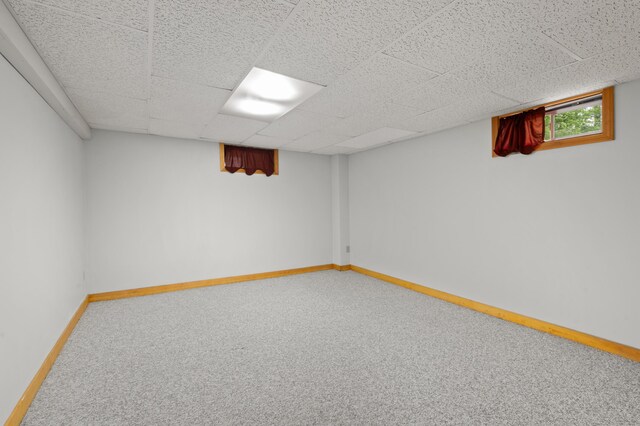55 Woodland St, Fryeburg, ME 04037 - below grade area featuring carpet floors, baseboards, and a paneled ceiling