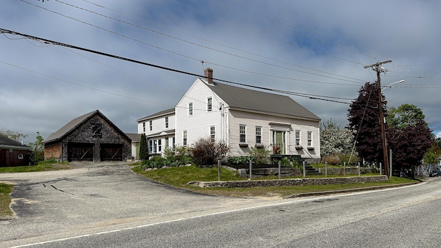 43 Main St, Harrison, ME 04040 - view of front facade with an outdoor structure, a garage, a barn, metal roof, and a chimney