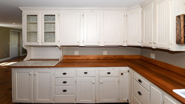 43 Main St, Harrison, ME 04040 - kitchen with white cabinetry, glass insert cabinets, baseboards, and dark wood finished floors