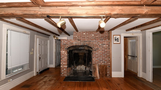 43 Main St, Harrison, ME 04040 - unfurnished living room with beamed ceiling, a fireplace, hardwood / wood-style flooring, and baseboards