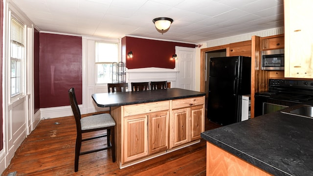 43 Main St, Harrison, ME 04040 - kitchen with black appliances, dark countertops, dark wood-style flooring, a kitchen breakfast bar, and a center island