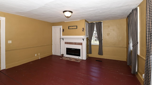 43 Main St, Harrison, ME 04040 - unfurnished living room featuring a fireplace with flush hearth and wood finished floors