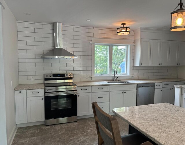 30 Elm St, Fort Kent, ME 04743 - kitchen featuring appliances with stainless steel finishes, wall chimney range hood, a sink, decorative backsplash, and white cabinetry