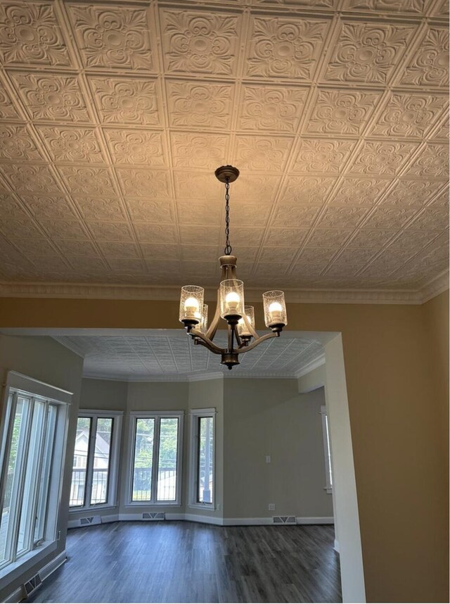 30 Elm St, Fort Kent, ME 04743 - detailed view of a chandelier, wood finished floors, ornamental molding, baseboards, and an ornate ceiling