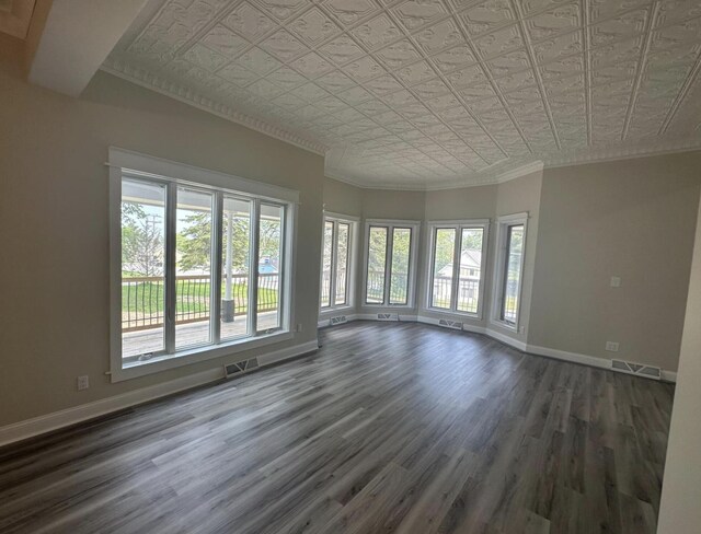30 Elm St, Fort Kent, ME 04743 - unfurnished room featuring an ornate ceiling, healthy amount of natural light, dark wood-type flooring, baseboards, and ornamental molding
