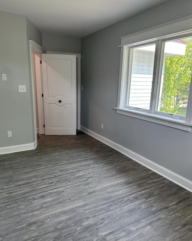 30 Elm St, Fort Kent, ME 04743 - unfurnished bedroom with multiple windows, baseboards, and wood finished floors