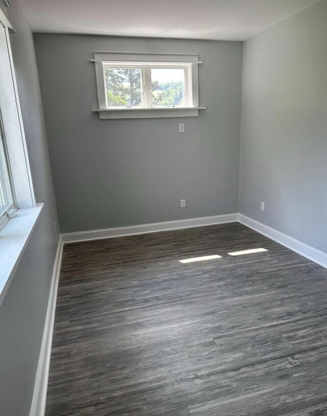 30 Elm St, Fort Kent, ME 04743 - spare room featuring dark wood-type flooring and baseboards