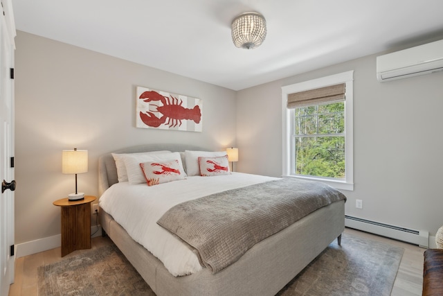 6 Roberts Ln, Kennebunkport, ME 04046 - bedroom featuring a baseboard heating unit, a wall mounted air conditioner, wood finished floors, and baseboards