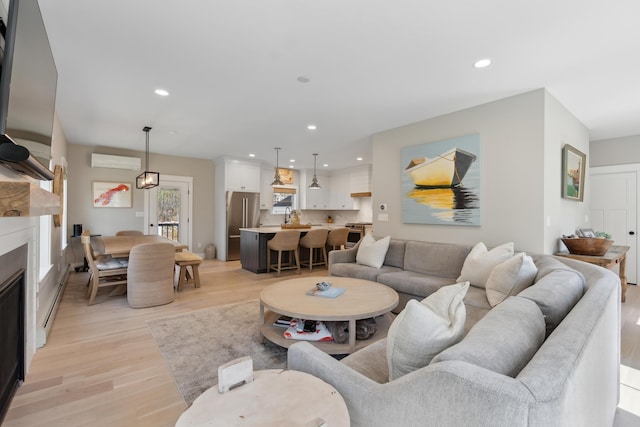 6 Roberts Ln, Kennebunkport, ME 04046 - living area with an AC wall unit, light wood-style floors, recessed lighting, and a glass covered fireplace