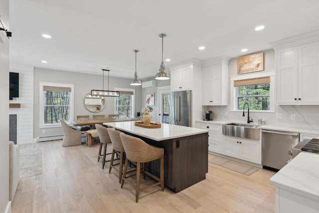 6 Roberts Ln, Kennebunkport, ME 04046 - kitchen with appliances with stainless steel finishes, a sink, light wood-type flooring, white cabinetry, and recessed lighting