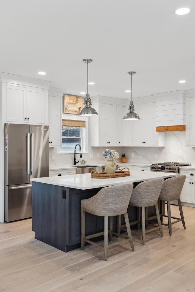 6 Roberts Ln, Kennebunkport, ME 04046 - kitchen featuring freestanding refrigerator, white cabinets, backsplash, a center island, and light countertops