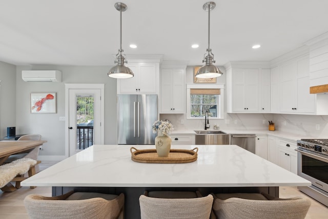 6 Roberts Ln, Kennebunkport, ME 04046 - kitchen with appliances with stainless steel finishes, an AC wall unit, a kitchen bar, healthy amount of natural light, and recessed lighting