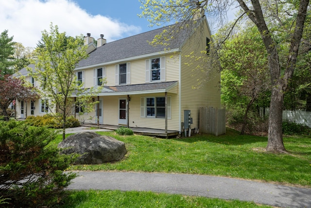48 Pine Hill Dr Unit 48, Bath, ME 04530 - view of front facade featuring a chimney, covered porch, a shingled roof, and a front lawn