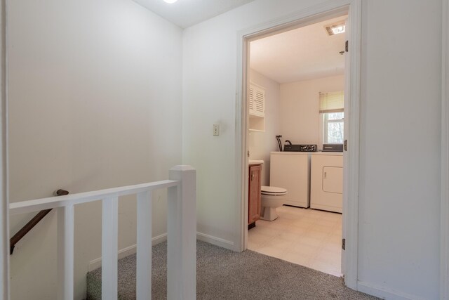 48 Pine Hill Dr Unit 48, Bath, ME 04530 - hall with washing machine and clothes dryer, light carpet, an upstairs landing, and baseboards