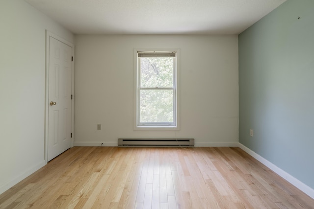 48 Pine Hill Dr Unit 48, Bath, ME 04530 - unfurnished room featuring a baseboard heating unit, light wood finished floors, and baseboards