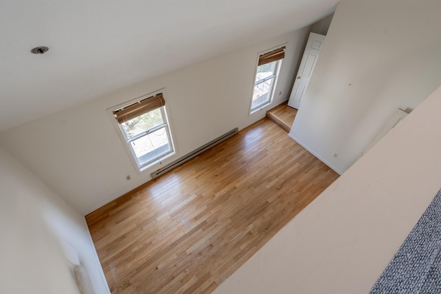 48 Pine Hill Dr Unit 48, Bath, ME 04530 - unfurnished living room with healthy amount of natural light, light wood-style floors, and a baseboard radiator