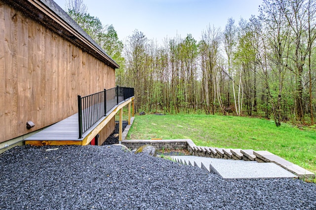 view of grassy yard featuring a deck