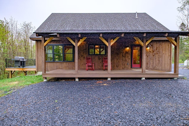 back of property featuring a shingled roof