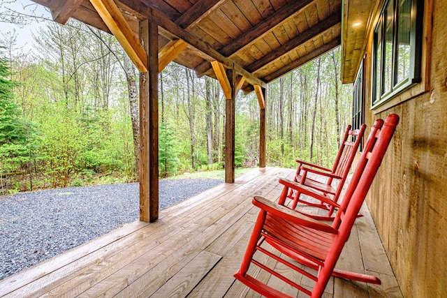 wooden terrace with a view of trees