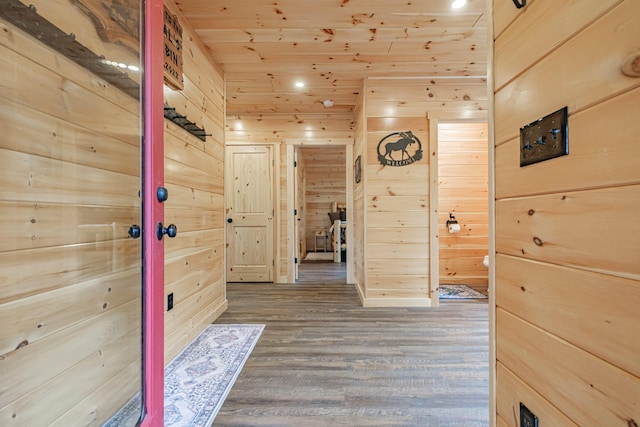 hall with wood walls, wood finished floors, wooden ceiling, and recessed lighting