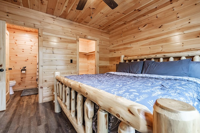 bedroom with wood ceiling, dark wood-style flooring, wood walls, and ensuite bath