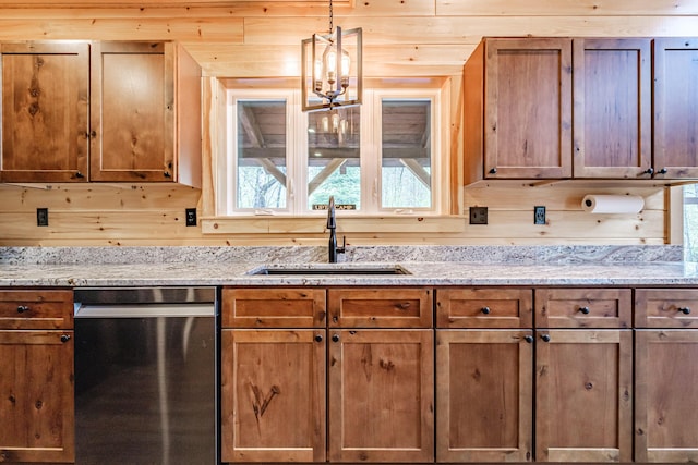 kitchen with dishwasher, a sink, decorative light fixtures, light stone countertops, and brown cabinets