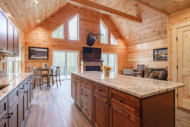 kitchen featuring wood walls, open floor plan, high vaulted ceiling, dark wood finished floors, and wooden ceiling