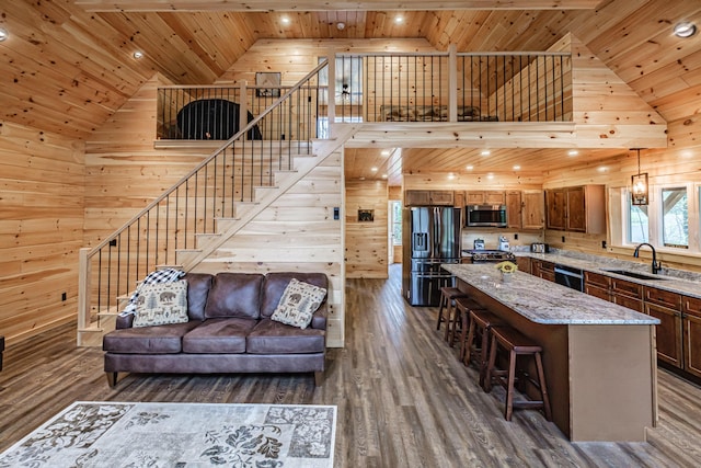 living room with wooden ceiling, wooden walls, dark wood-style floors, and stairs